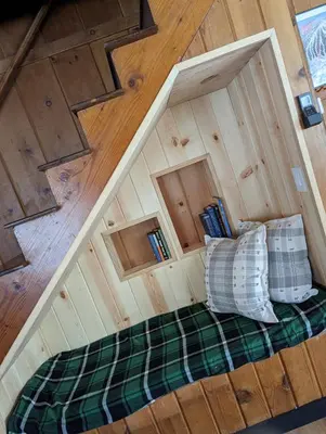 an inside view of a room with a bed and wooden floors at Cabin #8 in Strawberry