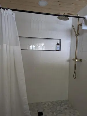 a shower with a shower curtain in a bathroom at Cabin #8 in Strawberry