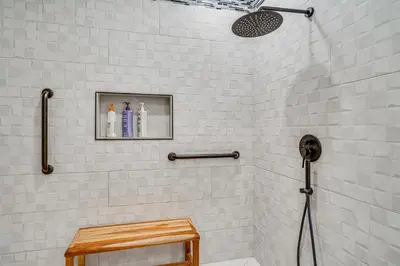 a white tiled shower with a shower head at Private Dock Discovery Bay Vacation Rental! in Discovery Bay
