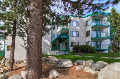 a large apartment building with trees in front of it at Heavenly Mountain Lake Retreat Near Skiing, Hiking & Biking in Stateline