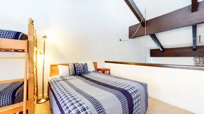 a bedroom with a bed and two bunk beds at Bridges #308 condo in Mammoth Lakes