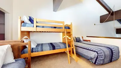 a room with two bunk beds in a room at Bridges #308 condo in Mammoth Lakes