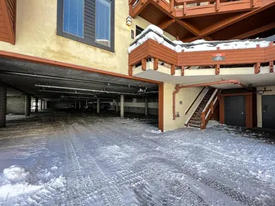 an empty parking lot with snow on the ground at Bridges #308 condo in Mammoth Lakes