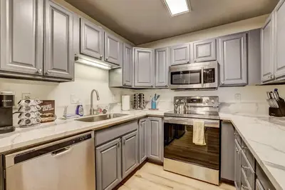 a kitchen with white cabinets and stainless steel appliances at Spacious Lakeview Heavenly Mountain Escape! in Stateline