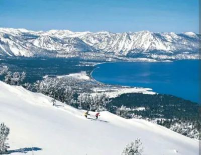 a group of people skiing down a snow covered slope at Spacious Lakeview Heavenly Mountain Escape! in Stateline