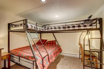 a bedroom with two bunk beds and a desk at Spacious Lakeview Heavenly Mountain Escape! in Stateline