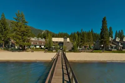 a wooden bridge over the water near a beach at Heavenly Lakeside Retreat Close to downtown in South Lake Tahoe