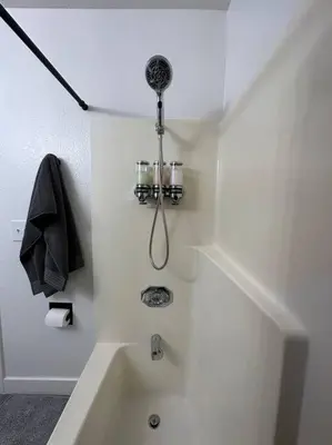 a white bathroom with a bath tub with a shower at Cozy Getaway with King bed & 70inTV in Carmichael
