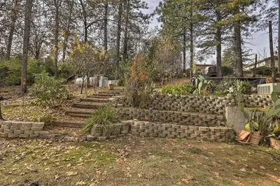 a retaining wall in a garden with some plants at Homey Colfax Getaway with Private Hot Tub! in Colfax