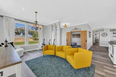 a living room with a yellow couch and a kitchen at Luxe & Comfy Vineyard Estate ~ Breathtaking Views! in Clarksburg