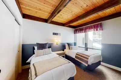 a bedroom with two beds and a window at Kingswood Village 60 in Kings Beach