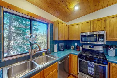 a kitchen with a sink and a window at Hansel Hideaway in Truckee