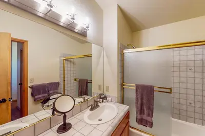 a bathroom with a sink and a mirror at Hansel Hideaway in Truckee