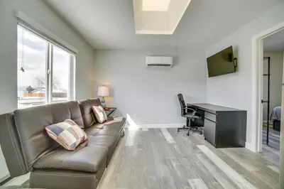 a living room with a couch and a desk at Renovated Hawthorne Apartment By Museums and Dining! in Hawthorne
