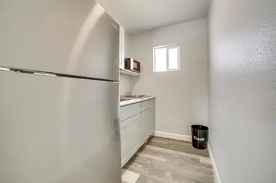 a white kitchen with a refrigerator and a sink at Updated Hawthorne Apartment, 12 Mi to Walker Lake! in Hawthorne