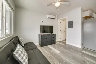 a living room with a couch and a flat screen tv at Updated Hawthorne Apartment, 12 Mi to Walker Lake! in Hawthorne