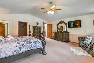 a bedroom with a bed and a ceiling fan at Minutes To Heavenly, Private Covered Hot Tub in South Lake Tahoe
