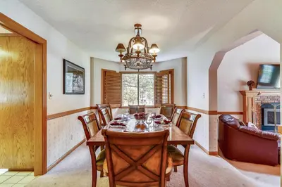 a dining room with a table and a chandelier at Minutes To Heavenly, Private Covered Hot Tub in South Lake Tahoe
