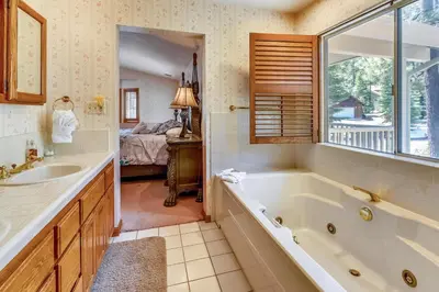 a bathroom with a tub and a sink at Minutes To Heavenly, Private Covered Hot Tub in South Lake Tahoe