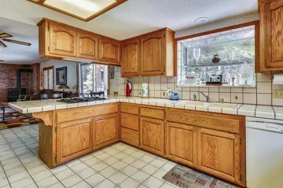 a kitchen with wooden cabinets and a window at Minutes To Heavenly, Private Covered Hot Tub in South Lake Tahoe