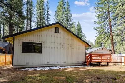 a white building with a black roof at Pet Friendly - Close To Heavenly, Steps To The River in South Lake Tahoe