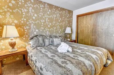 a bedroom with a bed and a wall with flowers at Pet Friendly - Close To Heavenly, Steps To The River in South Lake Tahoe