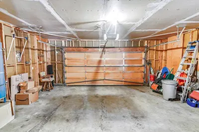 a garage with a large wooden garage door at Pet Friendly - Close To Heavenly, Steps To The River in South Lake Tahoe