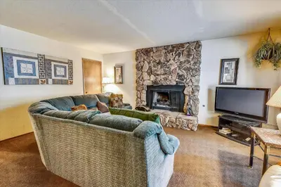 a living room with a couch and a fireplace at Pet Friendly - Close To Heavenly, Steps To The River in South Lake Tahoe