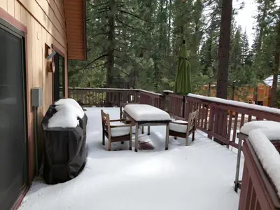 a deck covered in snow with a table and chairs at Cabin Close To Hiking Trails And Ski Resorts in South Lake Tahoe