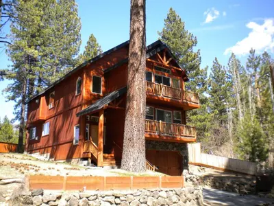 a log cabin with a tree in front of it at Close To Everything Newly Built With Games Room in South Lake Tahoe