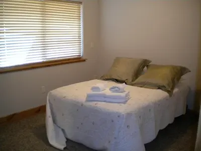 a bed with towels on it in a bedroom at Close To Everything Newly Built With Games Room in South Lake Tahoe