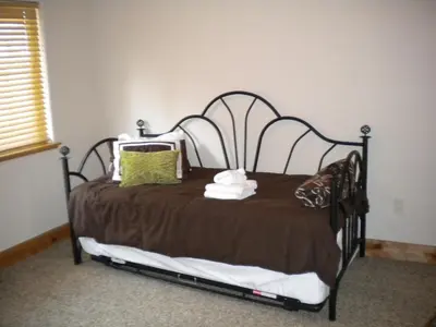 a bed with a brown blanket and pillows on it at Close To Everything Newly Built With Games Room in South Lake Tahoe