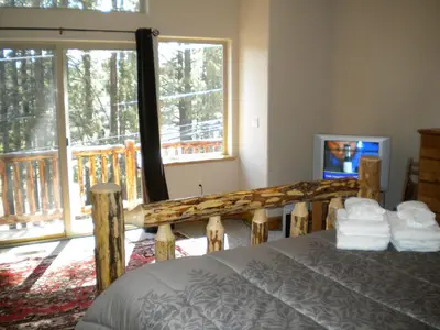 a bedroom with a bed and a large window at Close To Everything Newly Built With Games Room in South Lake Tahoe