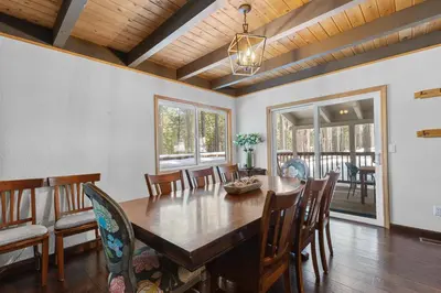 a dining room with a wooden table and chairs at Bigfoot Cabin in Camp Connell