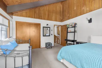 a bedroom with a bed and a wooden ceiling at Bigfoot Cabin in Camp Connell