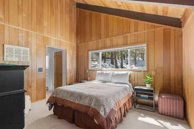 a bedroom with a bed and a window at Bigfoot Cabin in Camp Connell