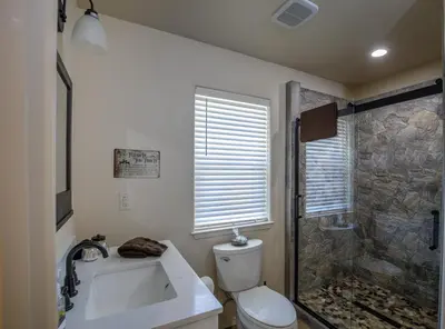 a bathroom with a shower and a toilet and a sink at Bear Paw Cabin new construction near Yosemite in Mariposa