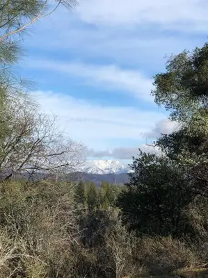 a view of a snow covered mountain in the distance at Bear Paw Cabin new construction near Yosemite in Mariposa