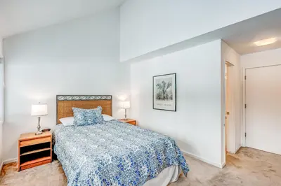 a bedroom with a bed with a blue bedspread at Championship Pines in Incline Village