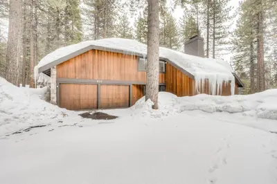 a wooden house in the woods in the snow at Championship Pines in Incline Village