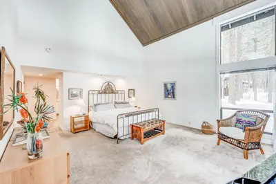 a bedroom with a bed and a large window at Championship Pines in Incline Village