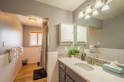 a bathroom with a sink and a mirror at Cherry Cottage 15 min from Yosemite South Entrance in Oakhurst