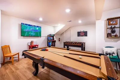 a room with a pool table and a tv at Sugarpine Trailhead Lodge at Lewis Creek Upper Trailhead just 7 miles from Yosemite in Oakhurst
