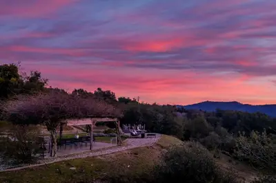 a picnic shelter on a hill at sunset at Fairy Tale 13-acre Sunset Villa at Windy Gap Valley near Yosemite in Ahwahnee