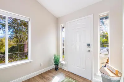 an empty room with a door and windows at Mystic Mountain Villa, 14 miles from Yosemite in Oakhurst