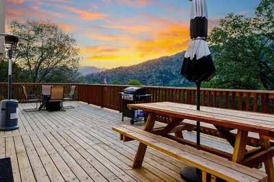 a wooden deck with an umbrella and a picnic table at Casita 3 Rios Secluded Mountain Top Home Minutes to Sequoias & Kings Canyon in Three Rivers