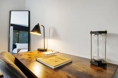 a table with a book and a lamp on it at Casita 3 Rios Secluded Mountain Top Home Minutes to Sequoias & Kings Canyon in Three Rivers