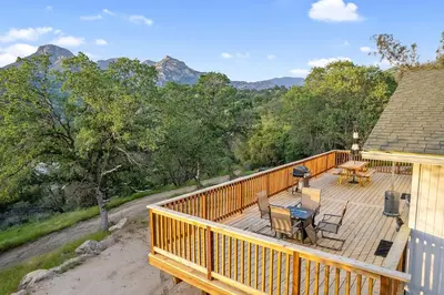 a wooden deck with a table and chairs on it at Casita 3 Rios Secluded Mountain Top Home Minutes to Sequoias & Kings Canyon in Three Rivers