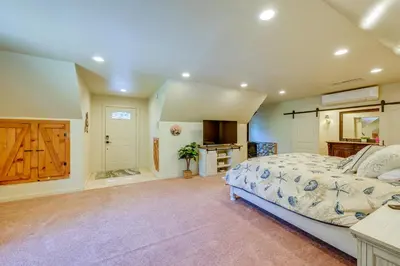 a bedroom with a large bed and a bathroom at Lakeside Bear Lodge Studio 9 Mi to Bass Lake! in Bass Lake Annex