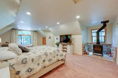 a bedroom with a large bed and a fireplace at Lakeside Bear Lodge Studio 9 Mi to Bass Lake! in Bass Lake Annex